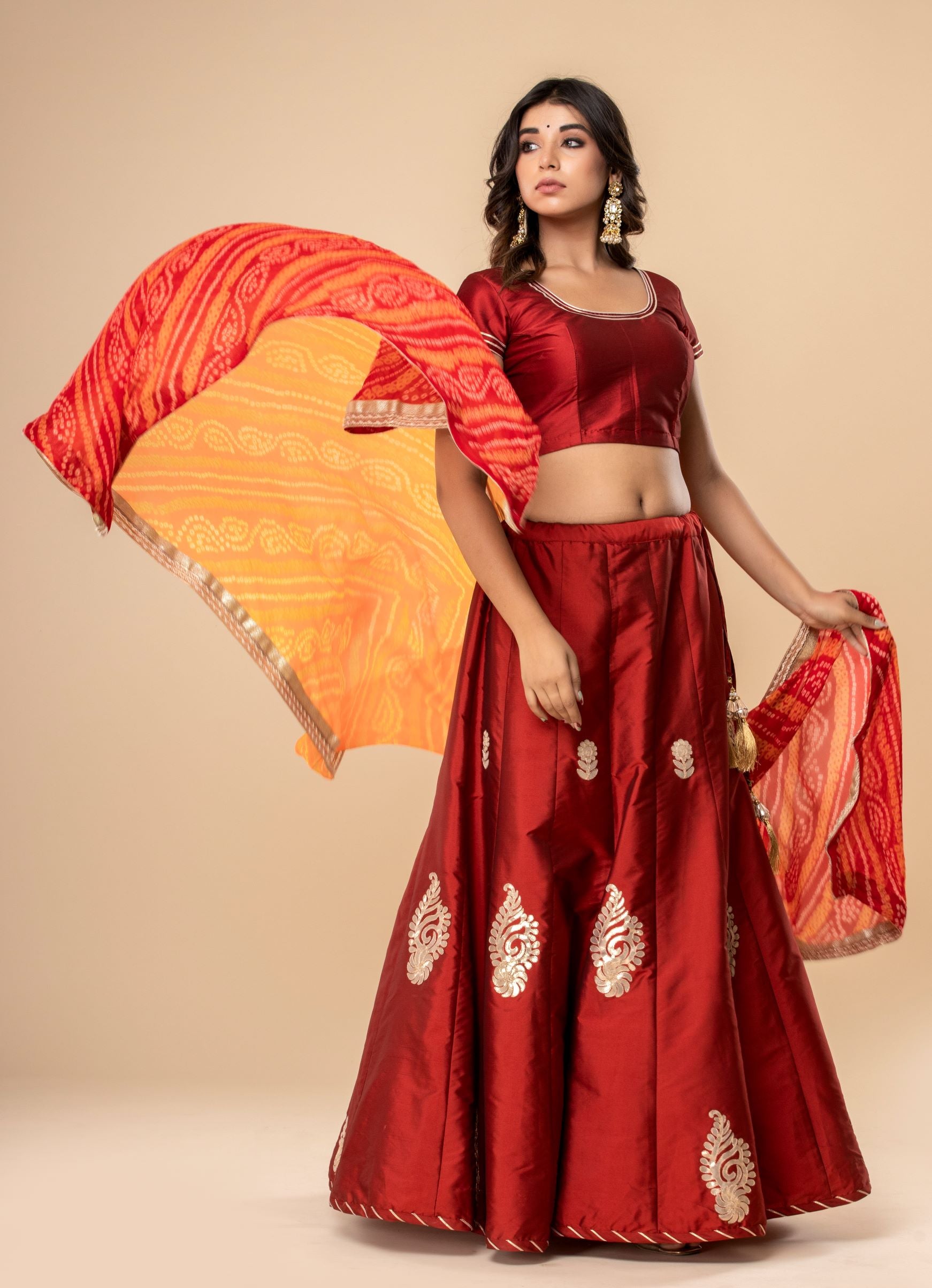 Butter Silk Lehenga And Blouse In Maroon With A Georgette Bandhani Dupatta